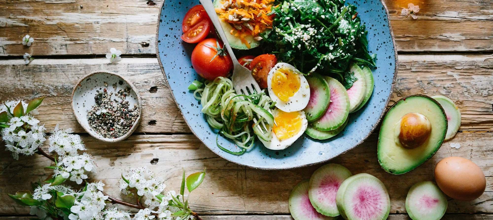 Fresh, wholefood ingredients laid out on a wooden table